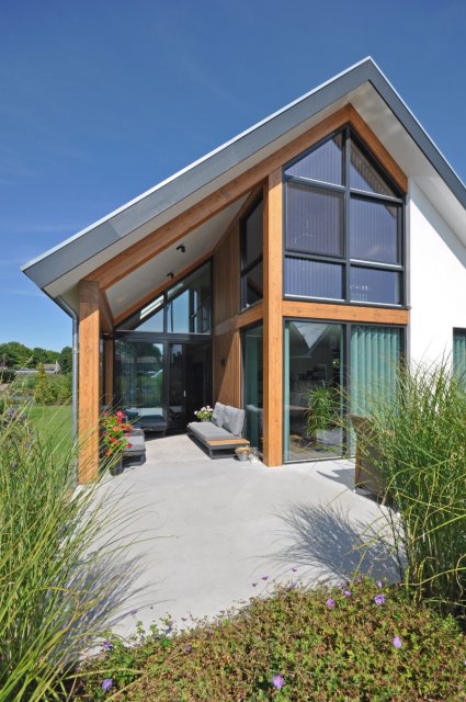 Woning met hoge glazen gevel, houten spanten en overdekt terras &ndash; licht en zicht in architectuur door architect Oud-Alblas