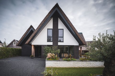 Moderne villa met rieten kap, zwarte gevelbekleding en strakke vormgeving &ndash; gerealiseerd door architectenbureau in Zuid-Holland
